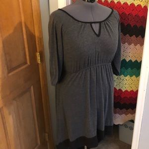 Black and grey knit dress with 3/4 length sleeves.